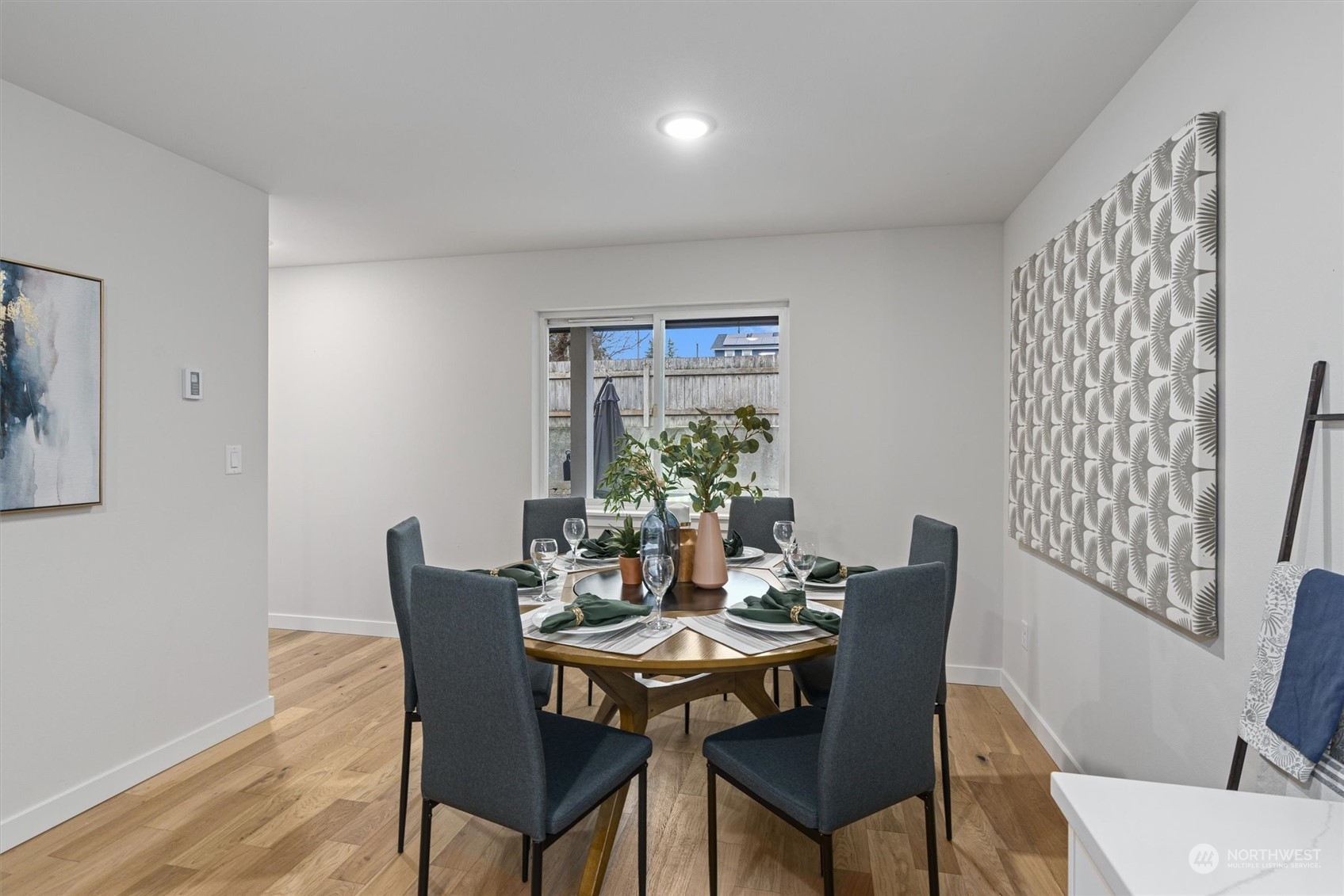 2412 Northwest 64th Street Seattle, WA 98107 - Photo 9 of 31 a view of a dining room with furniture and wooden floor