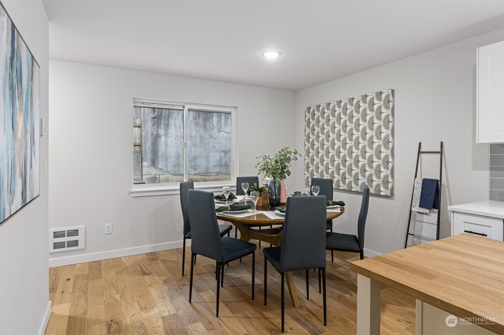 2412 Northwest 64th Street Seattle, WA 98107 - Photo 10 of 31 a view of a dining room with furniture and wooden floor