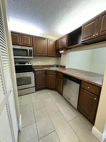 a kitchen with stainless steel appliances granite countertop a sink and stove top oven