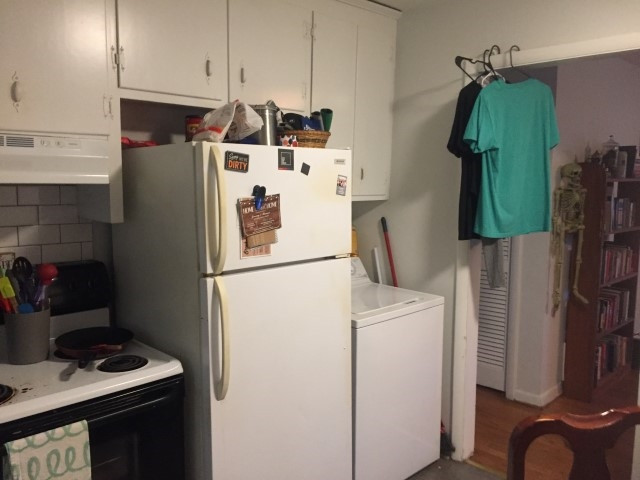 1121 Carlton Avenue Raleigh, NC 27606 - Photo 11 of 14 a white refrigerator freezer and a stove sitting inside of a kitchen