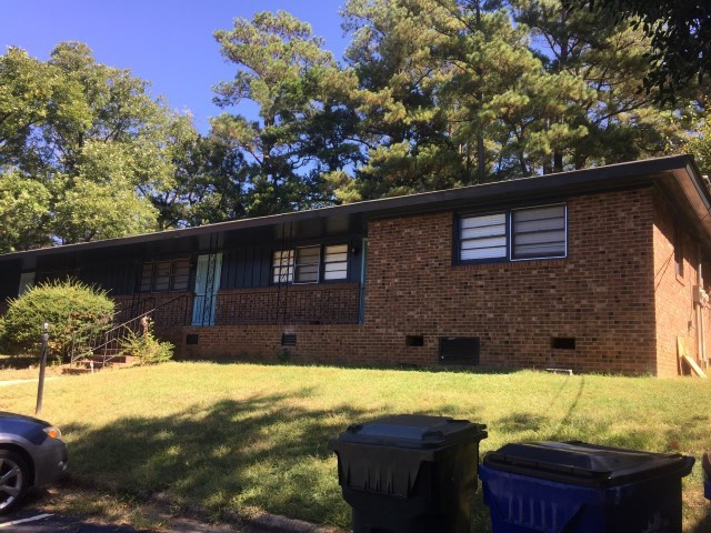 1121 Carlton Avenue Raleigh, NC 27606 - Photo 2 of 14 a backyard of a house with lots of green space