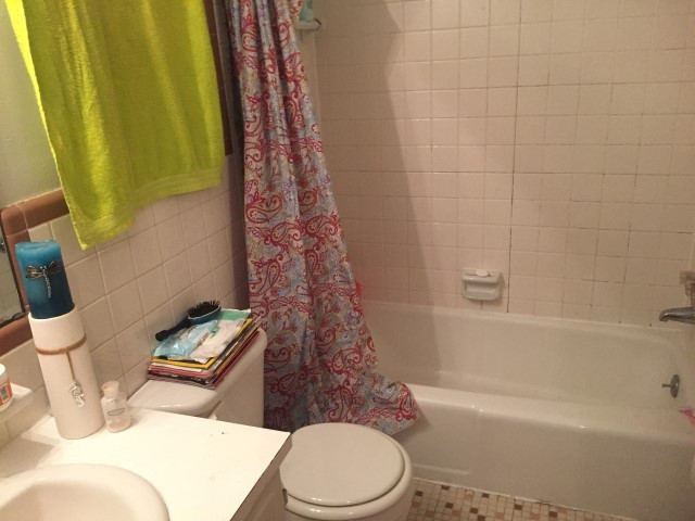 1121 Carlton Avenue Raleigh, NC 27606 - Photo 7 of 14 a bathroom with a toilet and a bathtub