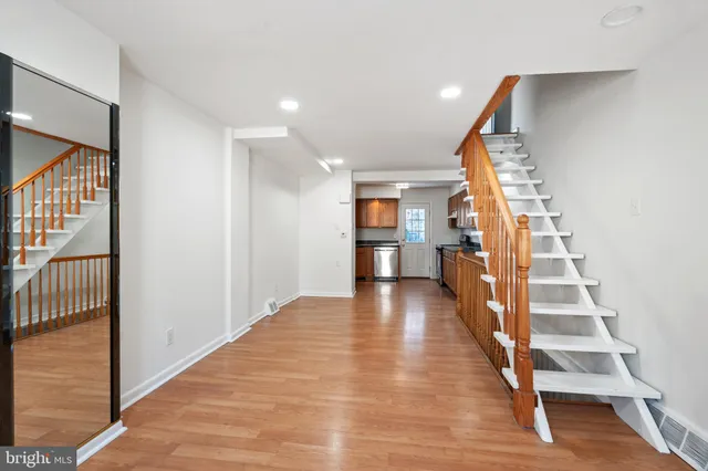 a view of entryway with wooden floor and stairs