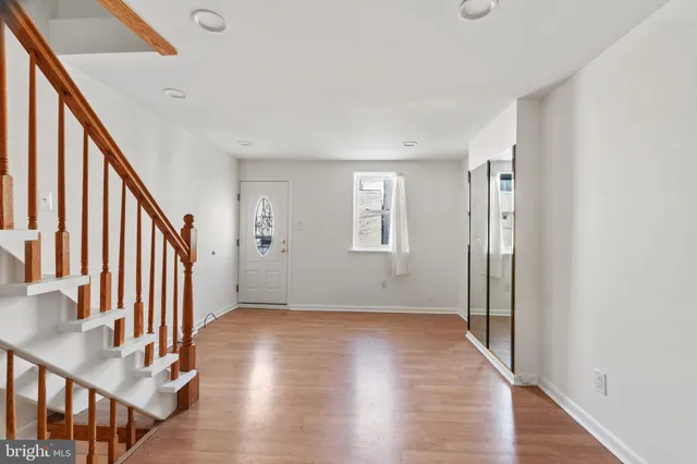 a view of an entryway with wooden floor