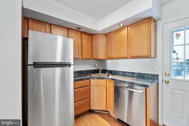a kitchen with a refrigerator sink and cabinets