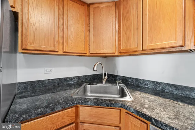 a kitchen with granite countertop a sink and cabinets