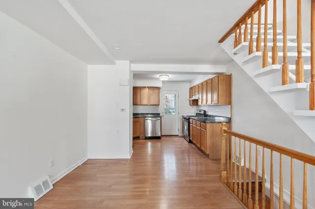 a view of a kitchen with a sink and dishwasher a refrigerator