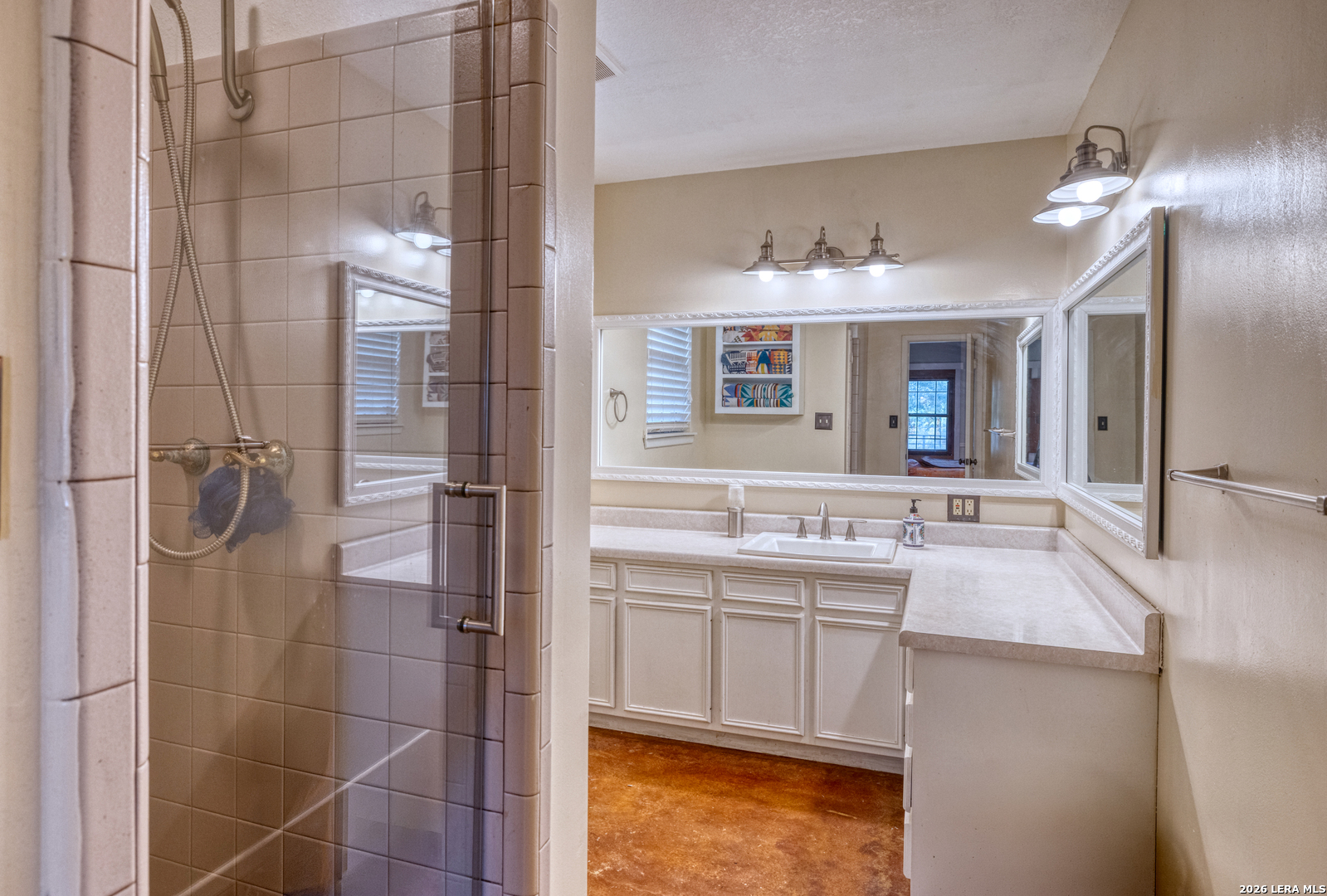 160 Beavers Trail Uvalde, TX 78801 - Photo 19 of 53 a bathroom with a granite countertop sink mirror and shower