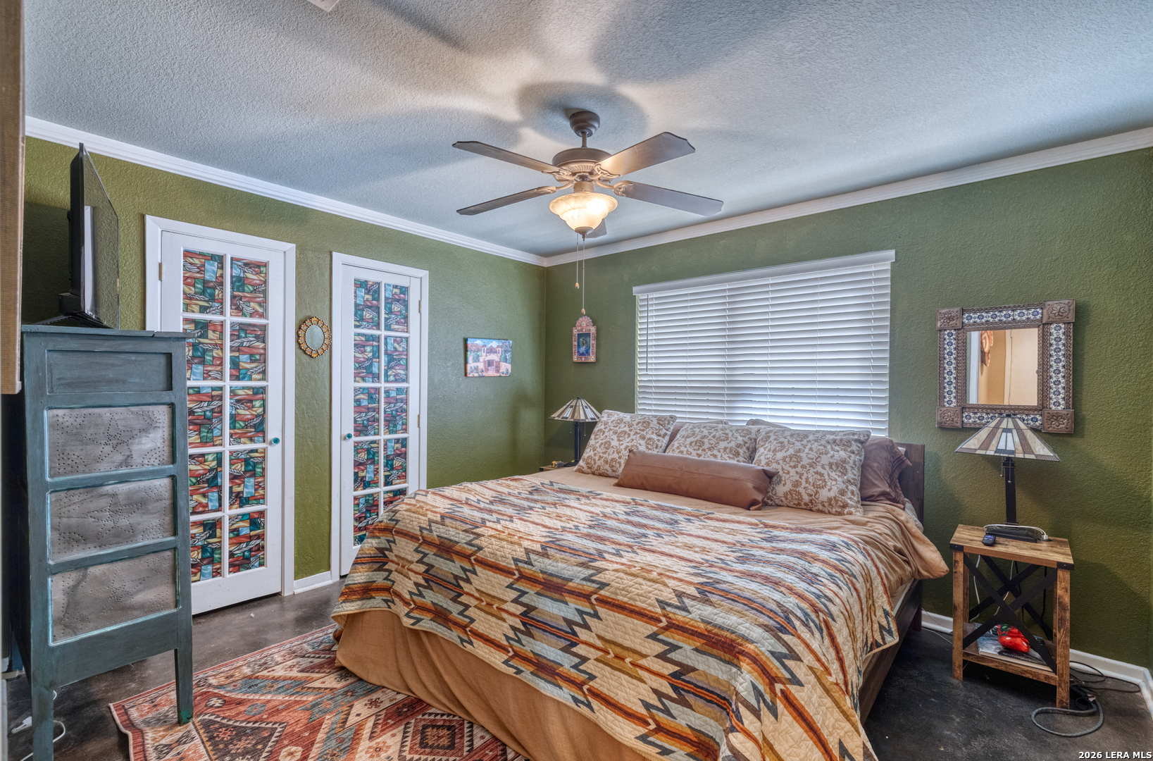 160 Beavers Trail Uvalde, TX 78801 - Photo 21 of 53 a bedroom with a large bed and a chandelier