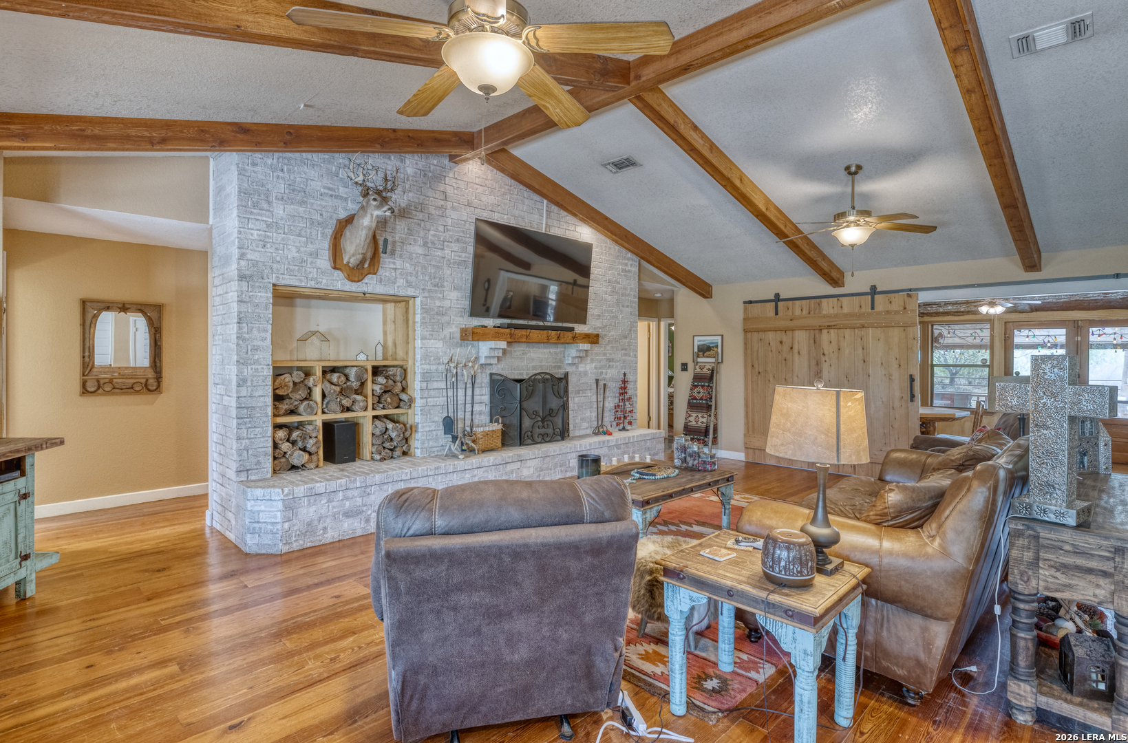 160 Beavers Trail Uvalde, TX 78801 - Photo 7 of 53 a living room with fireplace furniture and a wooden floor