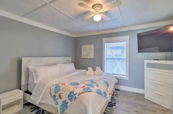 a living room with furniture a dining table and a chandelier