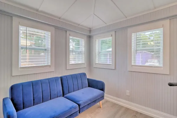 a kitchen with a refrigerator and white cabinets
