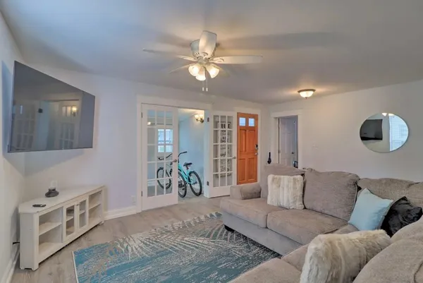 a living room with furniture and wooden floor