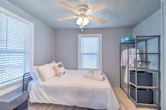 a bedroom with a bed and a chandelier