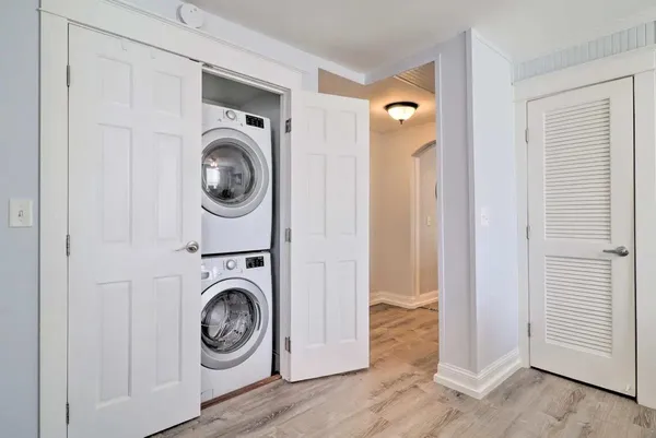 a bathroom with a granite countertop sink a mirror a shower and a bathtub