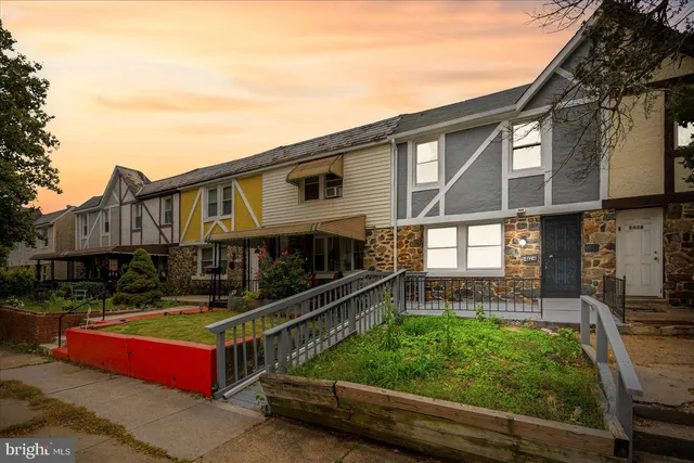 a view of a house with wooden deck and a backyard