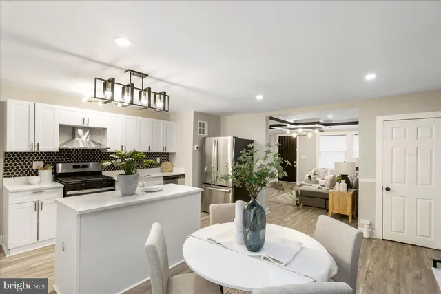 a kitchen with a table and chairs