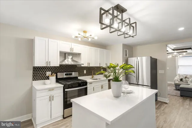 a kitchen with a refrigerator and a white cabinets