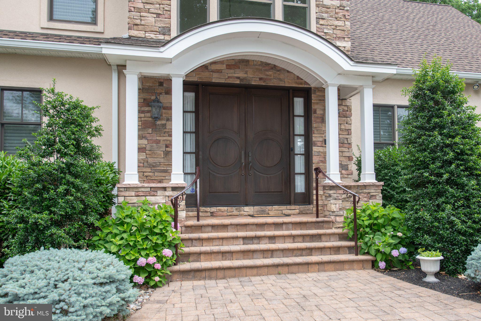 711 Moredon Road Jenkintown, PA 19046 - Photo 9 of 140 Elegant entrance with lush greenery.