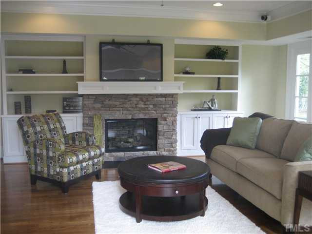 2214 Creston Road Raleigh, NC 27608 - Photo 20 of 24 Stone fireplace with custom mantle, built in cabinets and shelves.