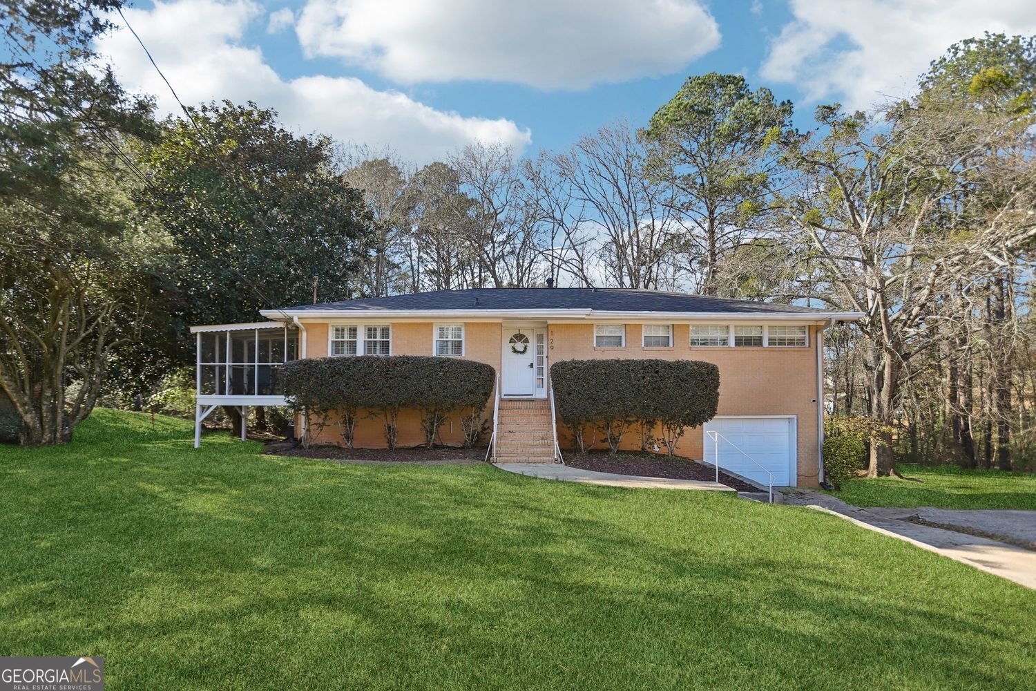 a view of an house with backyard space and sitting area