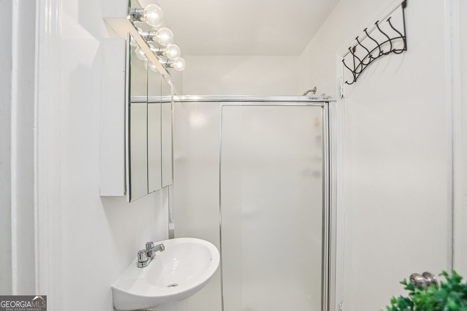 129 Tye Street Stockbridge, GA 30281 - Photo 14 of 27 a bathroom with a sink a mirror and a shower