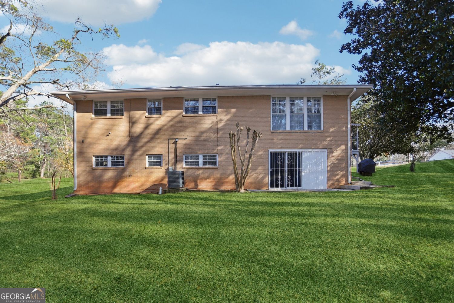 129 Tye Street Stockbridge, GA 30281 - Photo 22 of 27 a aerial view of a house next to a big yard and large trees