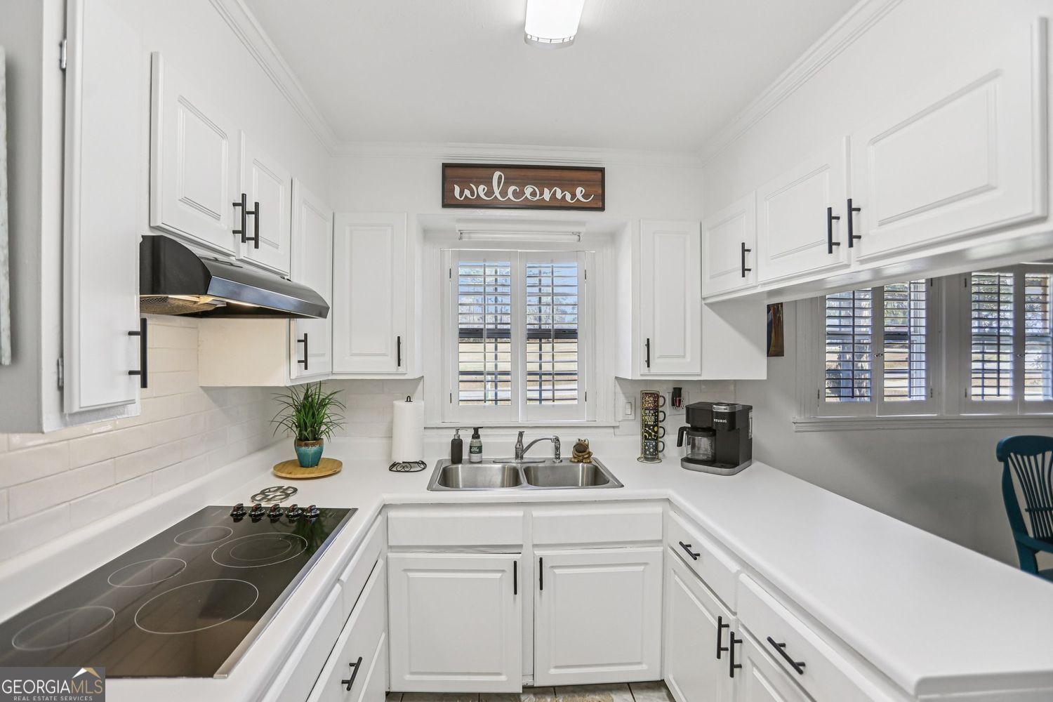129 Tye Street Stockbridge, GA 30281 - Photo 8 of 27 a kitchen with cabinets a sink a stove and a window