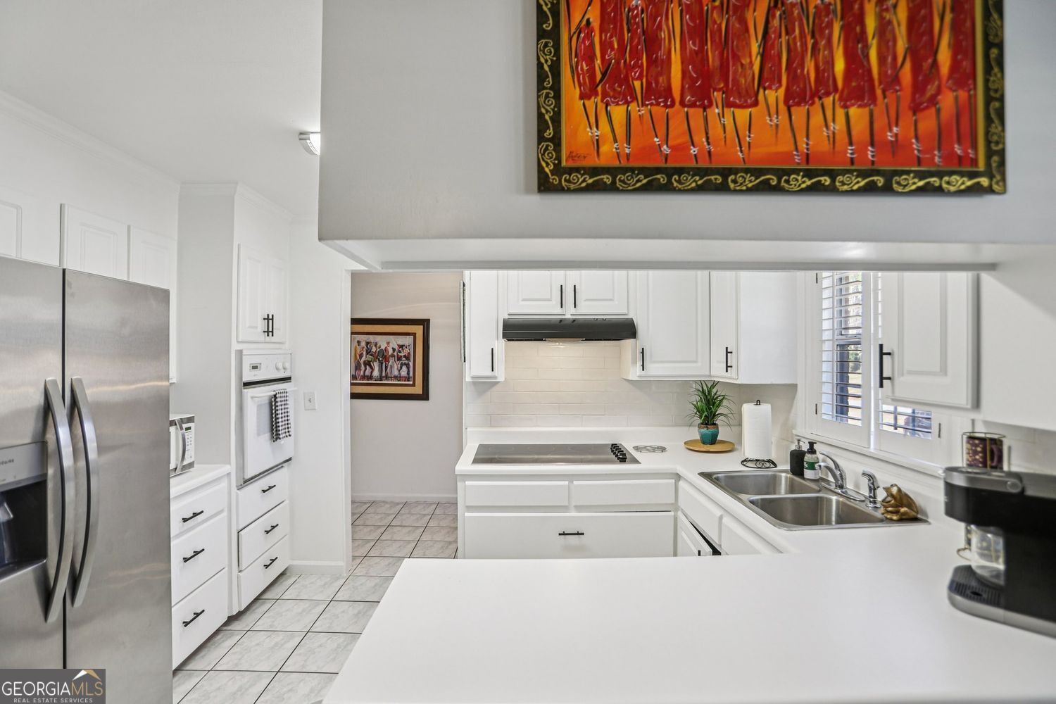 129 Tye Street Stockbridge, GA 30281 - Photo 9 of 27 a kitchen with stainless steel appliances a refrigerator sink and cabinets
