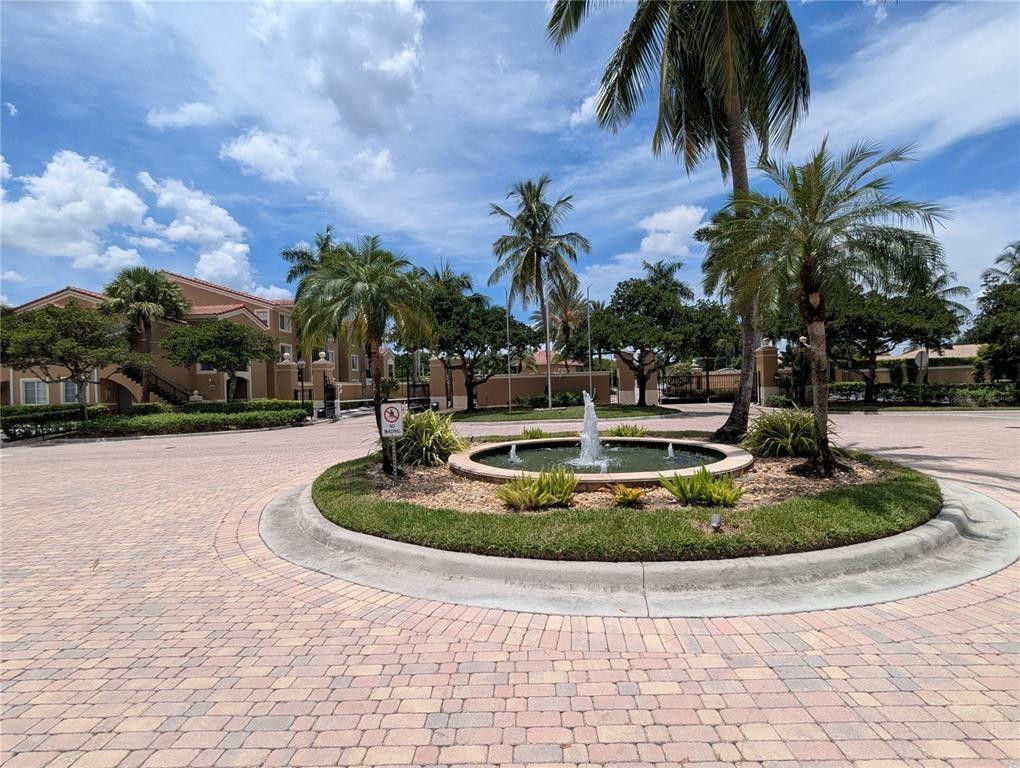 8010 North Nob Hill Road, Unit 205 Tamarac, FL 33321 - Photo 14 of 14 a view of a fountain with palm trees