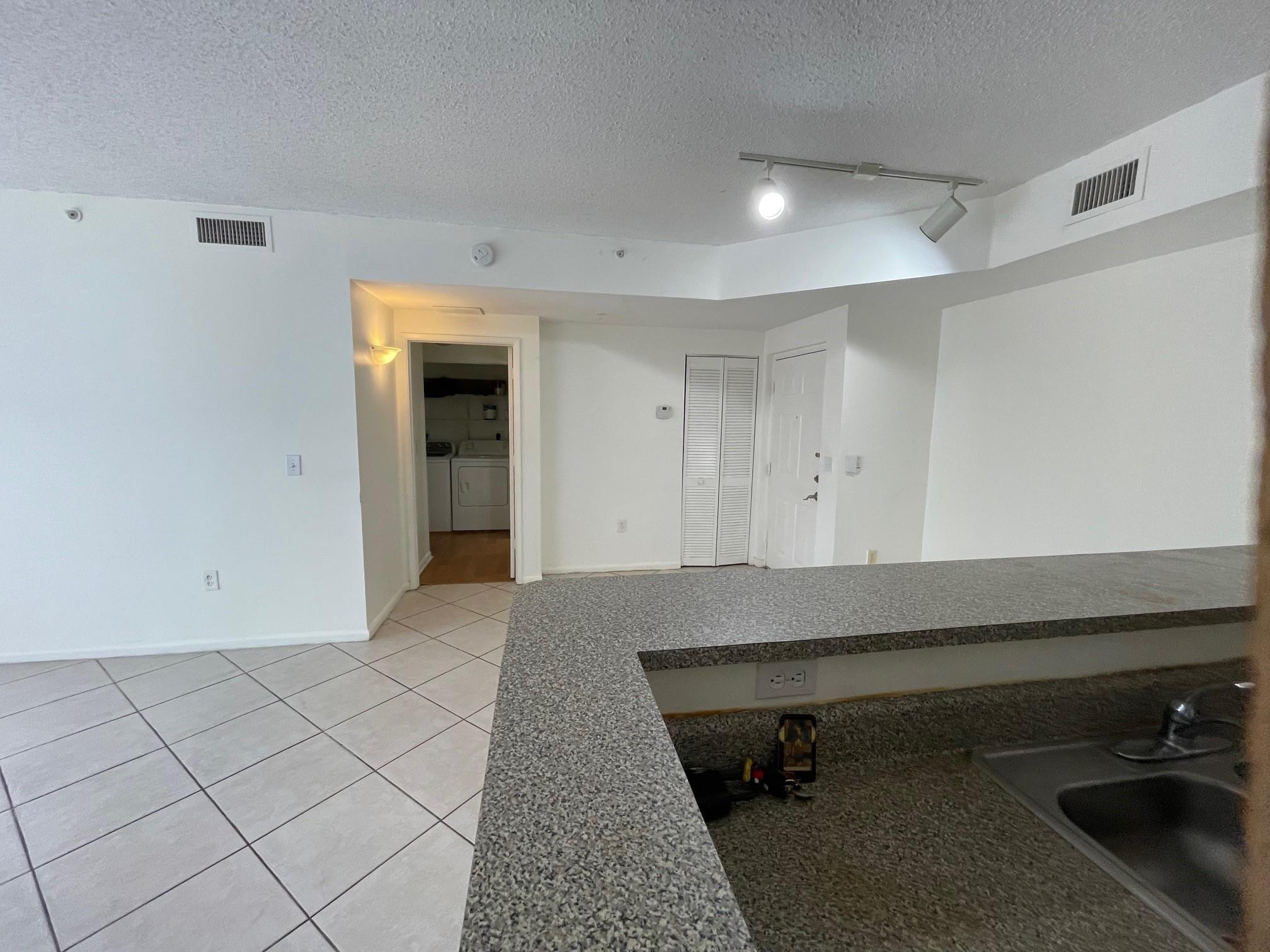 8010 North Nob Hill Road, Unit 205 Tamarac, FL 33321 - Photo 5 of 14 a room with a chair and white walls