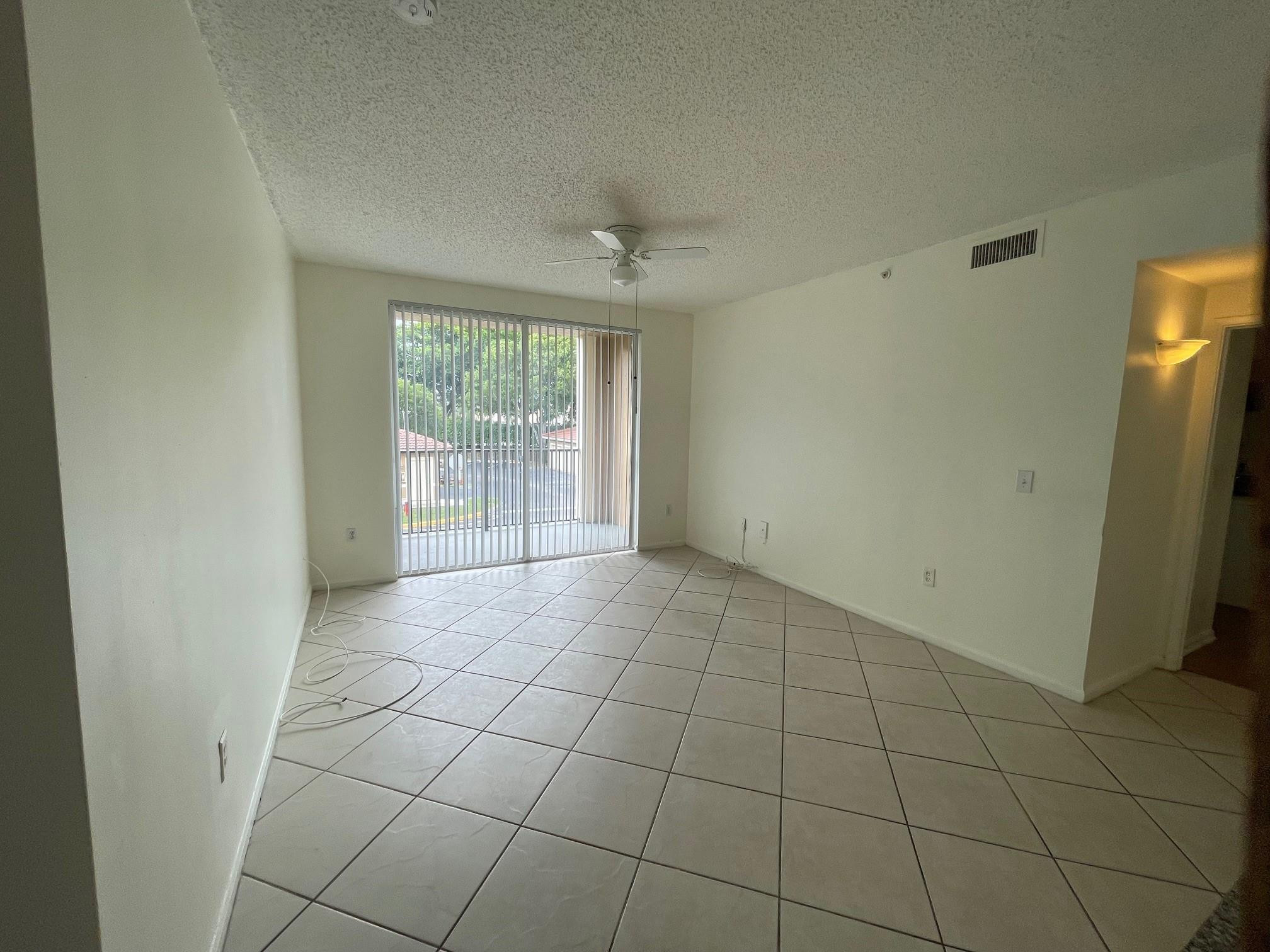 8010 North Nob Hill Road, Unit 205 Tamarac, FL 33321 - Photo 6 of 14 a view of an empty room with a window