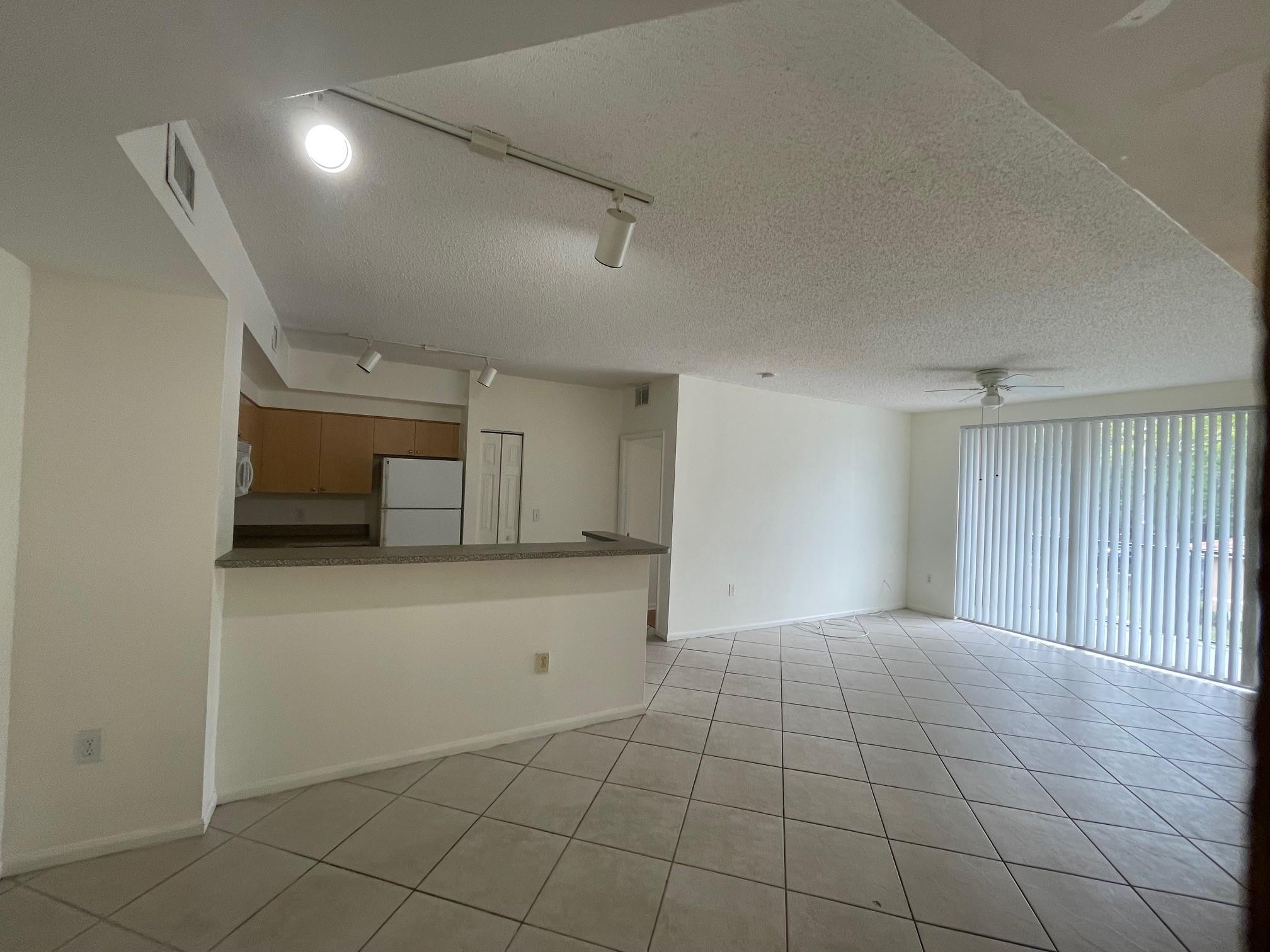 8010 North Nob Hill Road, Unit 205 Tamarac, FL 33321 - Photo 7 of 14 a view of an empty room with a window