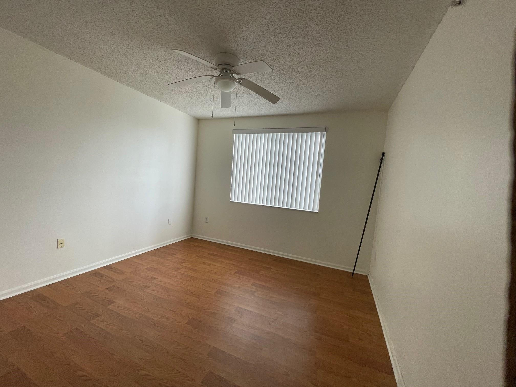 8010 North Nob Hill Road, Unit 205 Tamarac, FL 33321 - Photo 8 of 14 an empty room with windows