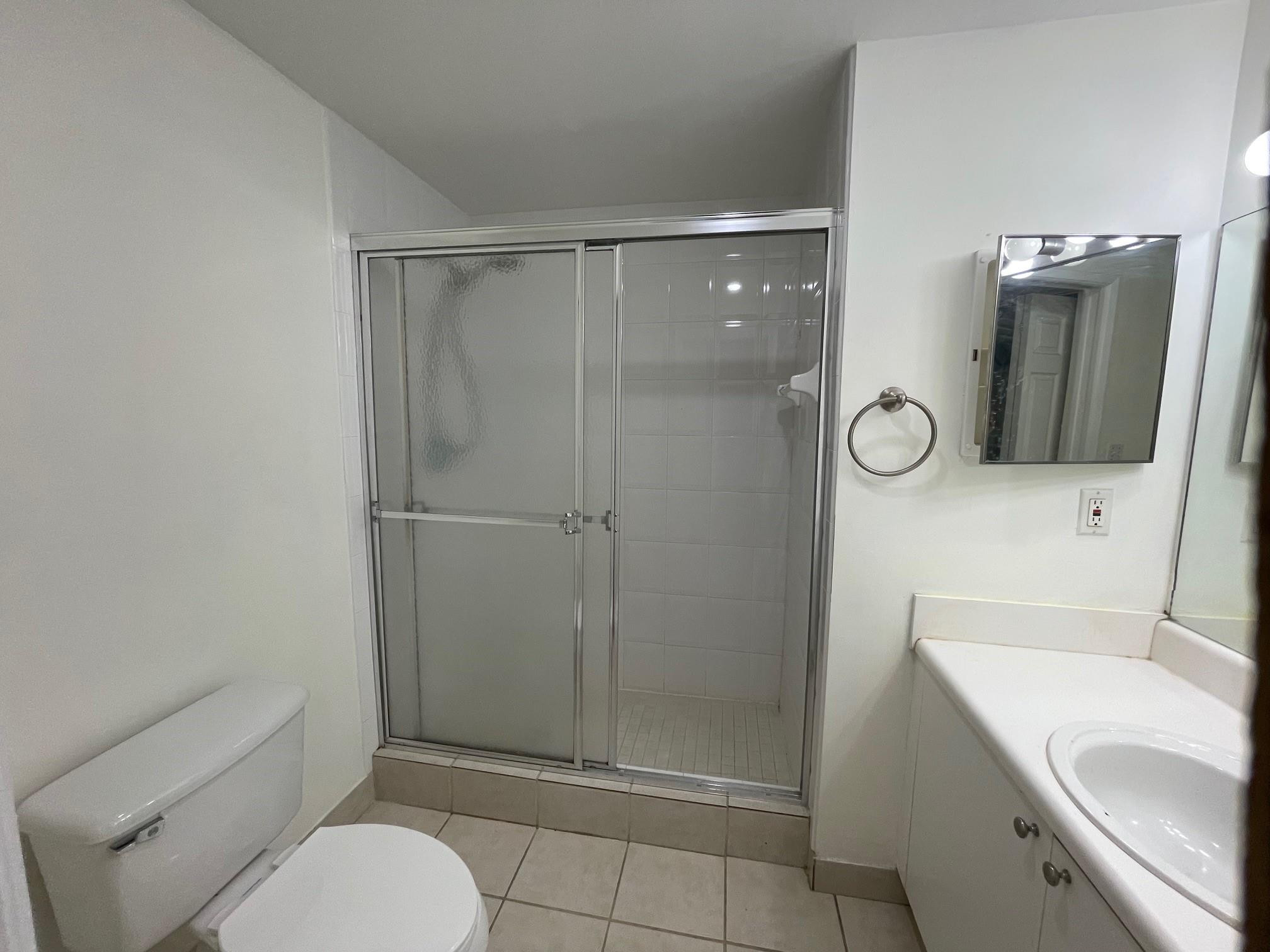 8010 North Nob Hill Road, Unit 205 Tamarac, FL 33321 - Photo 10 of 14 a bathroom with a sink a toilet and shower