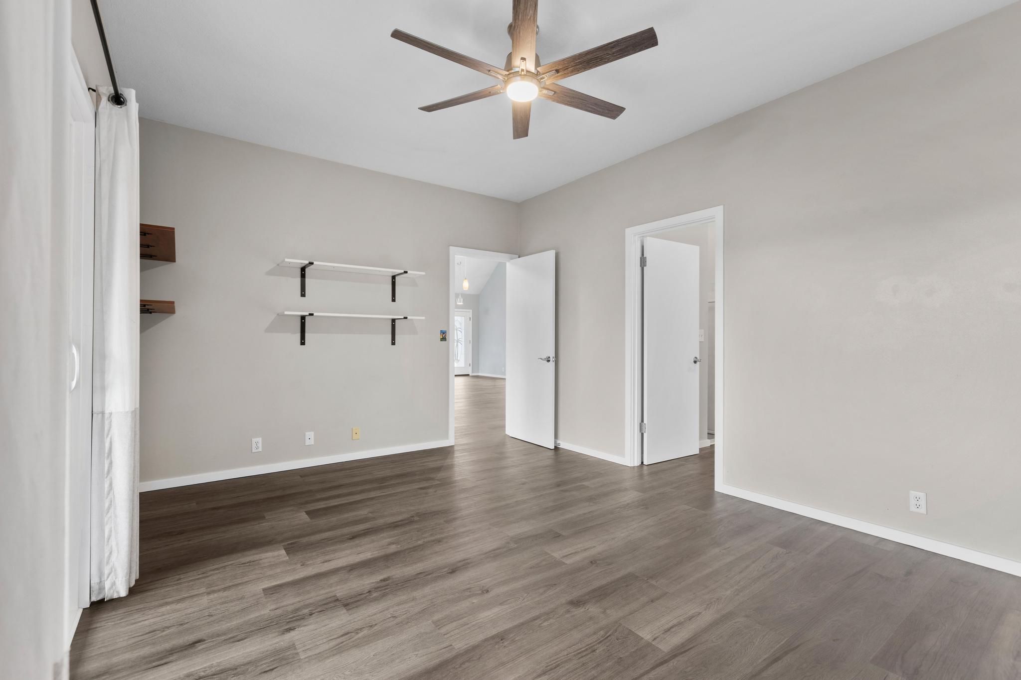 234 Kipa Street Hilo, HI 96720 - Photo 21 of 30 an empty room with wooden floor and a ceiling fan