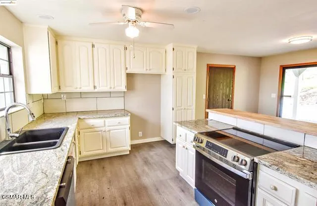 a kitchen with a sink and cabinets