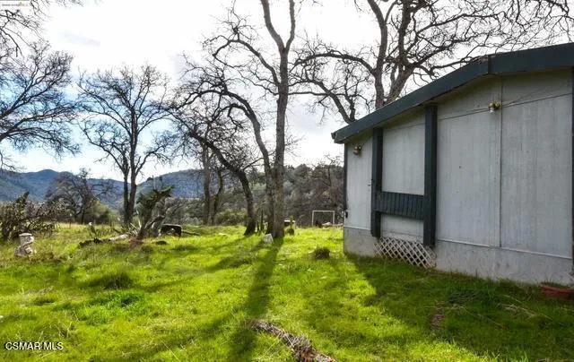 a view of a mountain with a yard