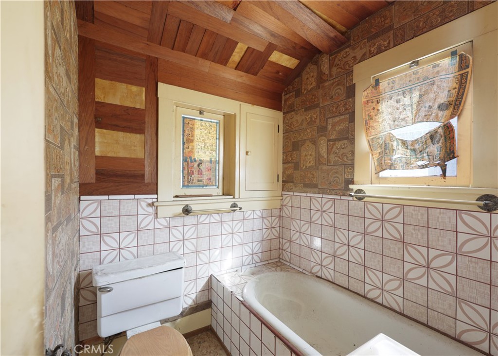 9211 Walnut Street Bellflower, CA 90706 - Photo 12 of 26 a bathroom with a bathtub and window