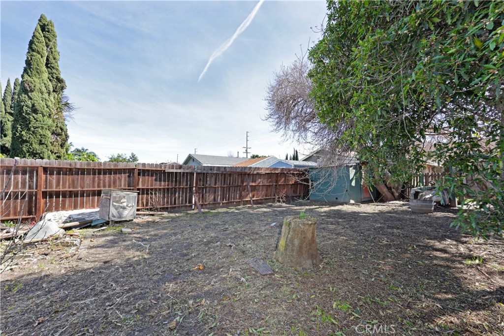 9211 Walnut Street Bellflower, CA 90706 - Photo 15 of 26 a backyard of a house with table and chairs