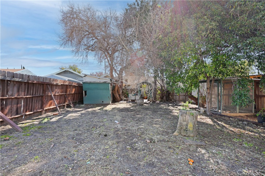 9211 Walnut Street Bellflower, CA 90706 - Photo 16 of 26 a backyard of a house with barbeque oven and table