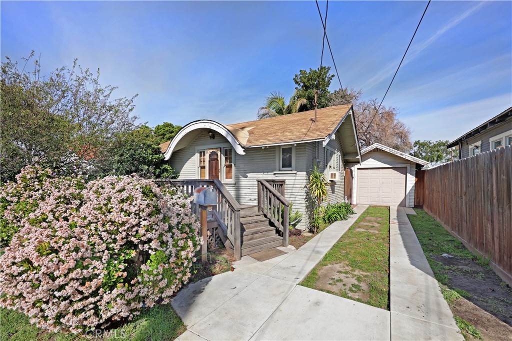 9211 Walnut Street Bellflower, CA 90706 - Photo 17 of 26 a view of a wooden house with a yard
