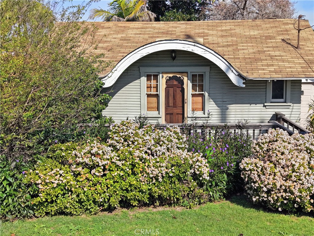 9211 Walnut Street Bellflower, CA 90706 - Photo 2 of 26 a front view of a house with garden