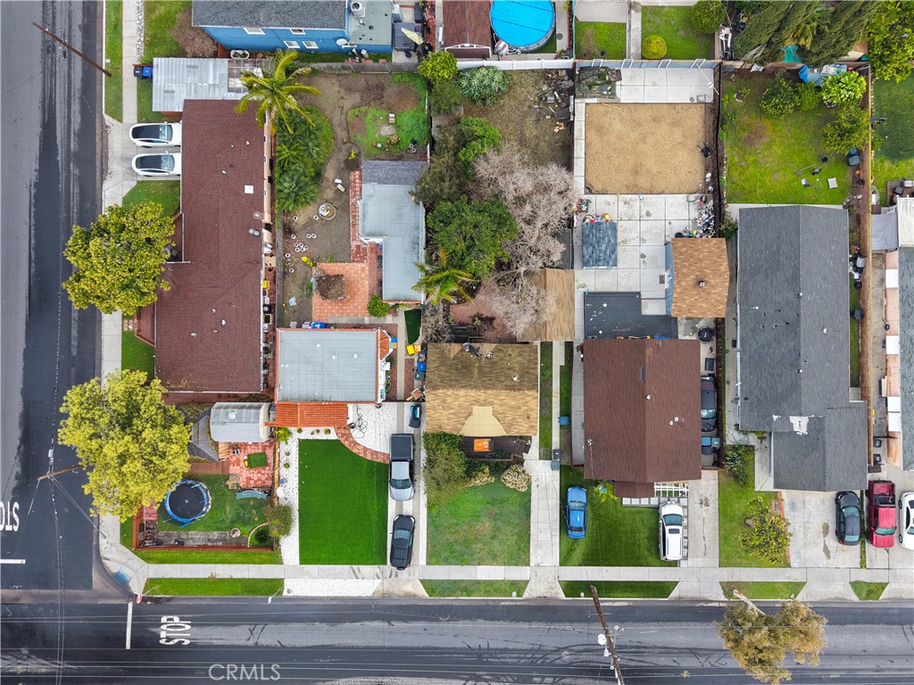 9211 Walnut Street Bellflower, CA 90706 - Photo 21 of 26 an aerial view of residential houses with outdoor space and parking