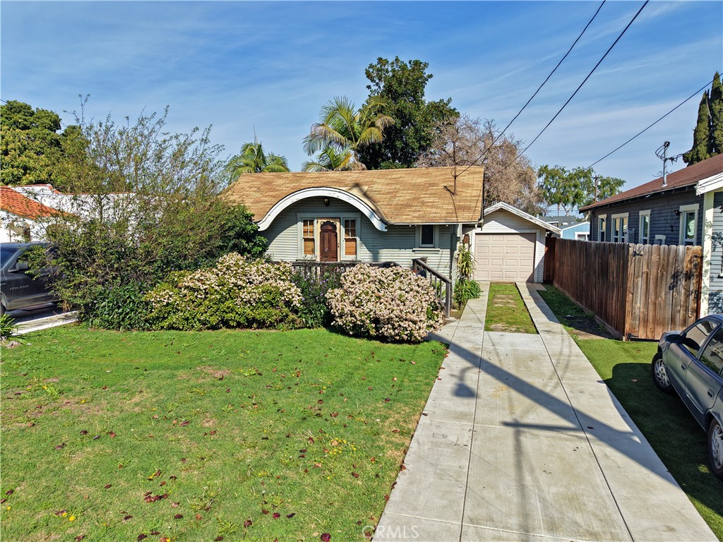 9211 Walnut Street Bellflower, CA 90706 - Photo 26 of 26 a view of front of house with a garden