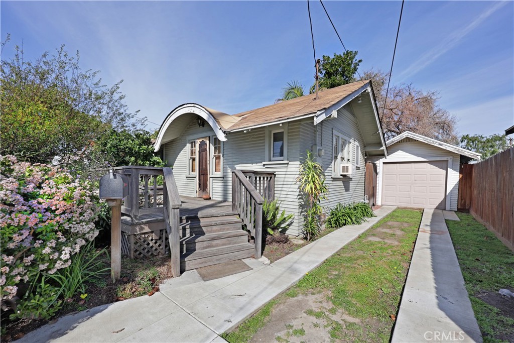 9211 Walnut Street Bellflower, CA 90706 - Photo 3 of 26 a front view of a house with garden
