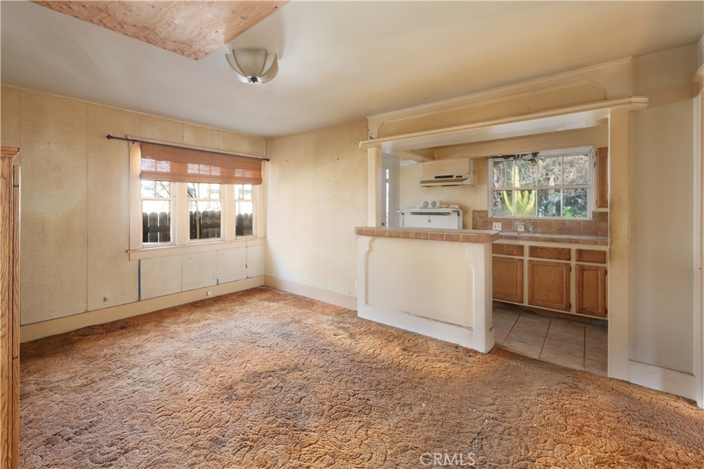 9211 Walnut Street Bellflower, CA 90706 - Photo 5 of 26 an empty room with a window and kitchen view