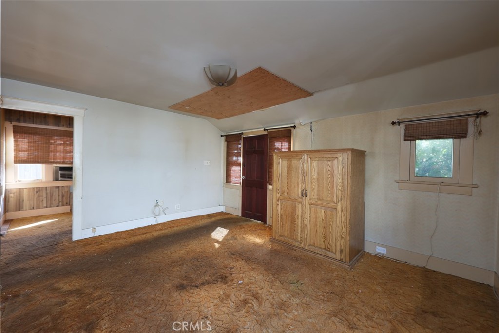 9211 Walnut Street Bellflower, CA 90706 - Photo 6 of 26 an empty room with closet and windows