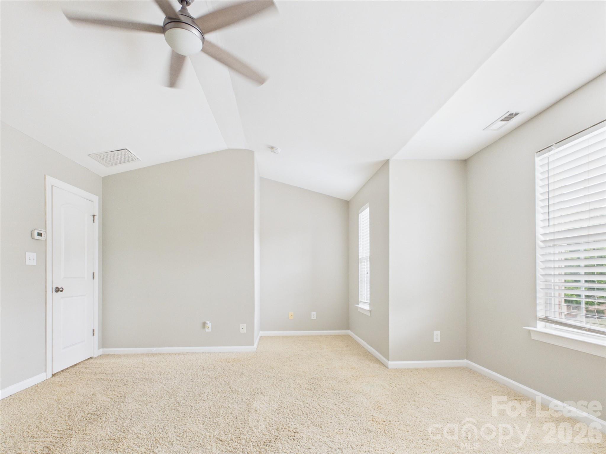 5690 Stafford Road Charlotte, NC 28215 - Photo 11 of 25 an empty room with windows and fan