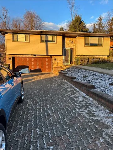a view of a house with a backyard